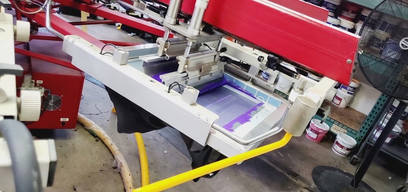 Ink being pulled through a screen on the press